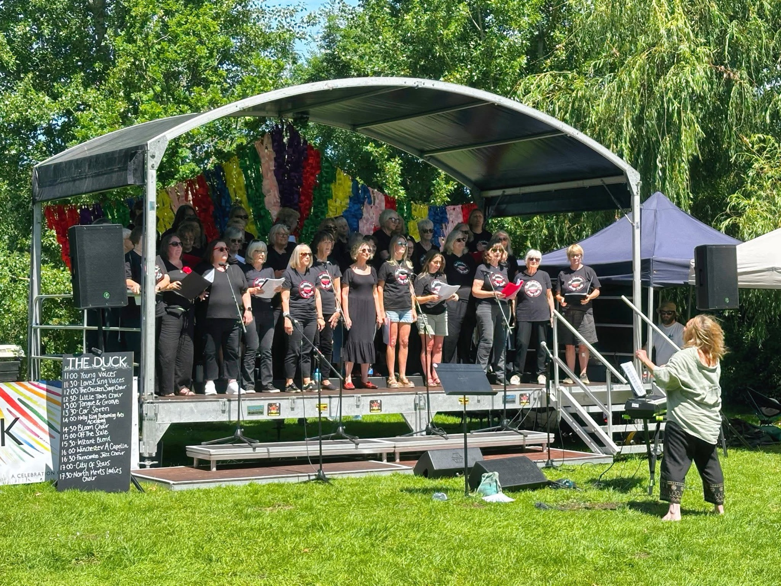 The Chicken Soup Choir performing in black T-shirts at ChoirBLAST